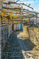 Traditional architecture  in a stone street during  fall season in the picturesque village of papigo in Epirus zagori greece