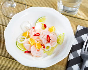 Shrimp ceviche with lime, mandarin and hot pepper served on plate