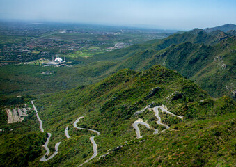 an aerial view of Faisal mosque along with zigzag road of margala hills in islamabad  