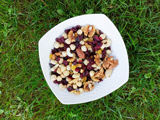 mixed nuts with raisins on a ceramic bowl