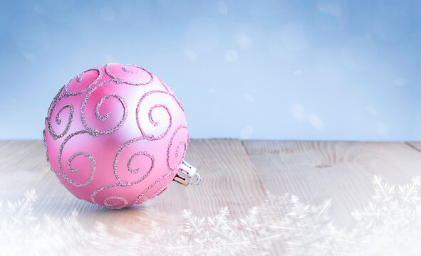 Pink Christmas Ornament On Wooden Table