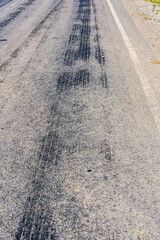 Tire tracks on the asphalt road. Brake traces