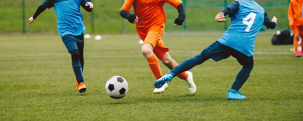 Boys Playing Soccer Game in Autumn Time. Footballers in Soccer Long Sleeve Jersey Clothing