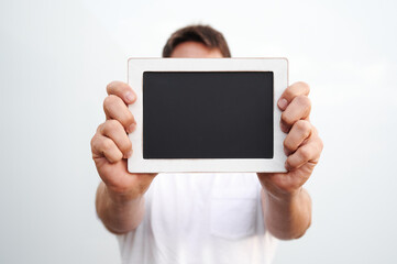 man holding chalkboard on white background