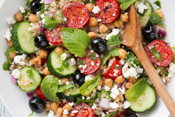 Vegetarian salad tomatoes, cucumbers, chickpeas, olives, herbs, cottage cheese, top view