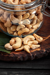 Bowl with cashew nuts on wooden table. Delicacies