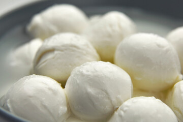 Fototapeta na wymiar Mozzarella balls with liquid. Traditional italian cheese.