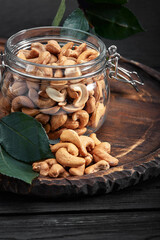 Bowl with cashew nuts on wooden table. Delicacies