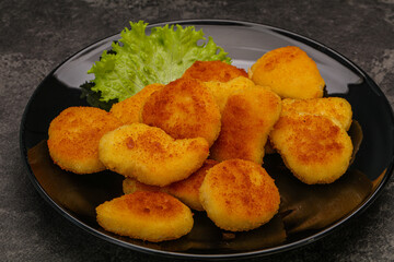 Fried chicken nuggets served salad leaves