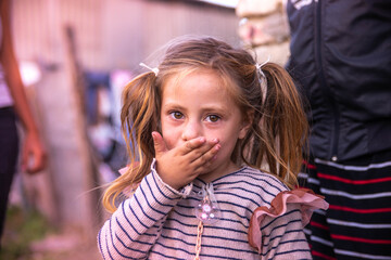 A cute little gypsy girl sending a kiss