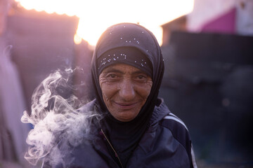 Portrait of an old gypsy woman smoking a cigarette
