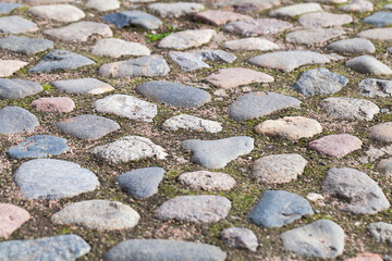 Old granite stone pavement, cobbled road texture
