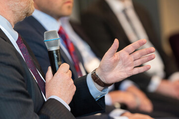 Man Asking a Question at Business or Academic Conference Event