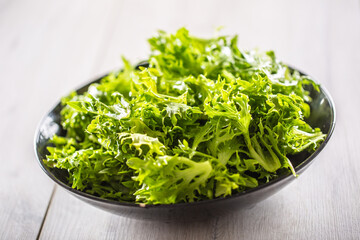 Bowl full of salad leaves on an isolated background
