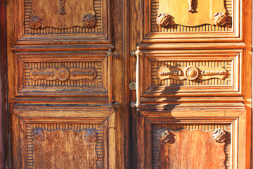 Decorative carved wooden door on historic building facade in Saint Petersburg, Russia. Ornamental door design, carving wood art details on building exterior