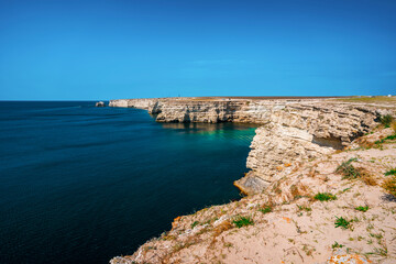 Fototapeta premium Black sea coastline with cliffs, rocks, turquoise waves and sea foam. Breathtaking, scenery landscape in Crimea