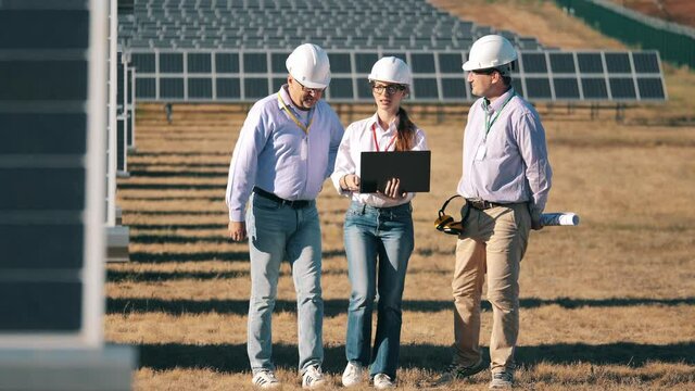 Energetics workers are walking along the solar power station