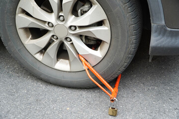 Locked wheel of a car parked in an improper place. Car wheels locked,