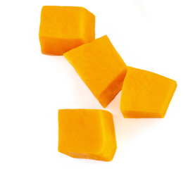 Diced Pumpkin  isolated on white background.  Fresh Pumpkin pieces cut in a cube slice, top view. Flat lay.