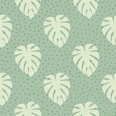 Vintage botanic seamless pattern with monstera doodle shapes. Light turquoise background with dots. Pastel tones floral print.