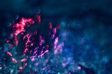 Beautiful multi colored abstract optical light bokeh on a dark background..