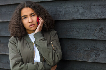 Sad Mixed Race African American Teenager Woman Using Cell Phone