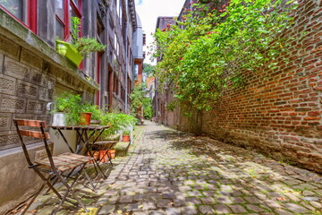 Old street with chair and plants in Liege, Belgium