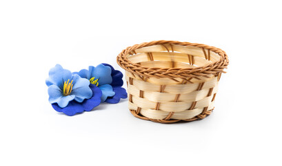 Decorative blue flowers wicker basket, harvesting composition, on white isolated background
