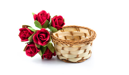 Fototapeta na wymiar Composition with wicker basket and decorative roses, on white isolated background