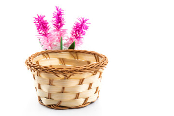 Composition of harvesting basket and pink flowers, on white isolated background