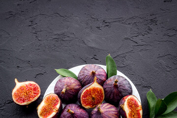 Fresh figs with green leaf, top view. Mediterranean fruit background