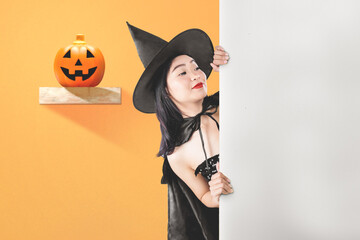 Asian witch woman with a hat standing with an empty board with a colored background