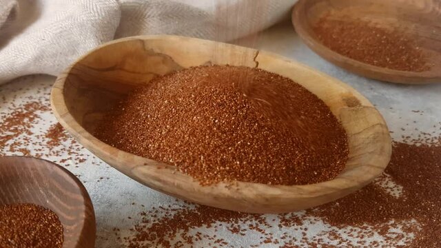 Raw teff grain in a wooden bowl close up