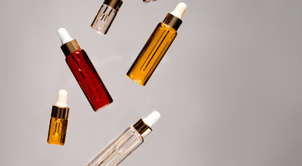 Natural hyaluronic serums flying. Natural materials and skin care concept. Horizontal view copyspace.