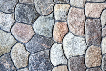 Obraz premium Natural rock wall texture and pattern. A surface or structure made of stone blocks.