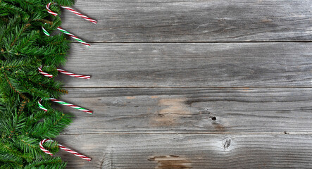 Merry Christmas and Happy New Year theme with holiday candy cane decorations on left side of weathered wooden boards