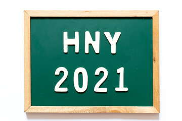 Obraz premium Green blackboard and wood frame with word HNY (Happy new year) 2021 on white background