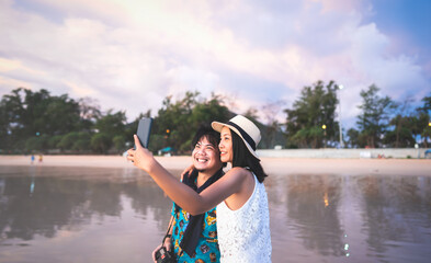 Relax adult asian people selfie by mobile phone at beach sea.