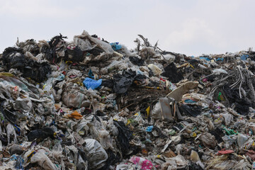 ภูเขาขยะพลาสติกจากชุมชนเมืองและเขตอุตสาหกรรมและท้องฟ้าสีคราม	