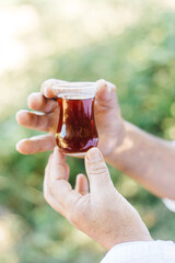 hand holding a glass of tea