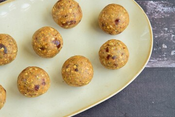 Sweet potato energy balls on a serving plate. Wooden background