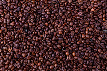 Freshly roasted coffee beans background. Coffee beans background. Background of roasted coffee beans.