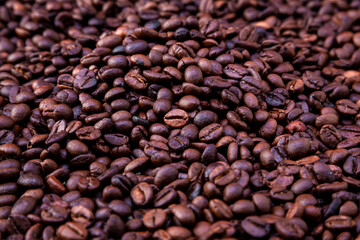 Freshly roasted coffee beans background. Coffee beans background. Background of roasted coffee beans.