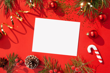 Christmas frame with Christmas tree decoration on a red background. Flat lay style