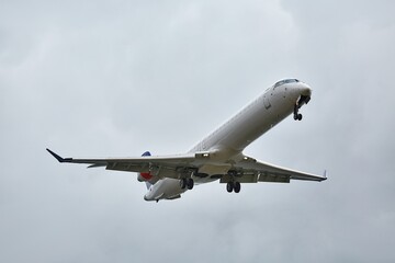 Plane approaching landing in cloudy overcast weather