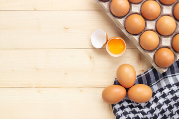 Egg yolk in egg shell with fresh egg in paper box. Food ingredient for hight protein.