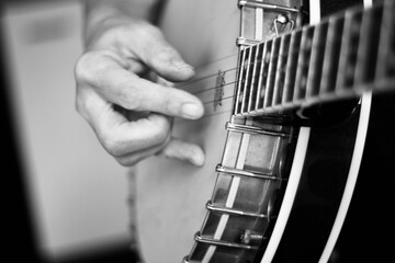 Close up of hands playing the banjo