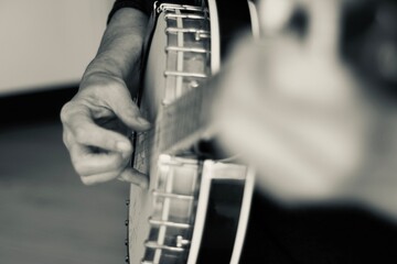 Close up of hands playing the banjo
