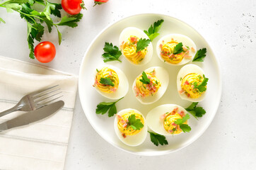 Stuffed eggs with egg yolk, bacon, mustard and parsley