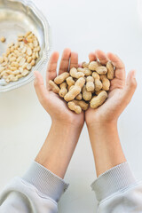 a handful of peanuts on a white background